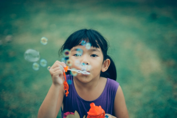 Asian little girl happy with water bubble